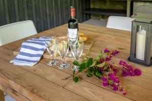Flowers, glasses and French wine on a table