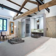 Interior of gite bedroom with exposed roof beams