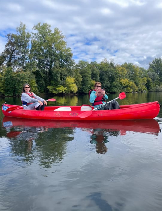 Two friends having fun in a canoe on the River Dordogne