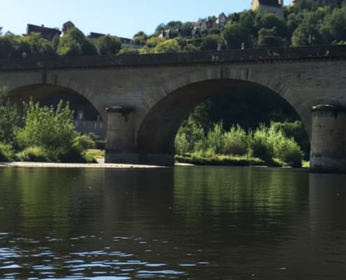 View of chateau on hill View of chateau on the hill and a bridge over the River Dordogne