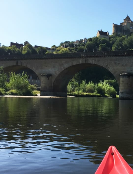 View of chateau on the hill and a bridge over the River Dordogne